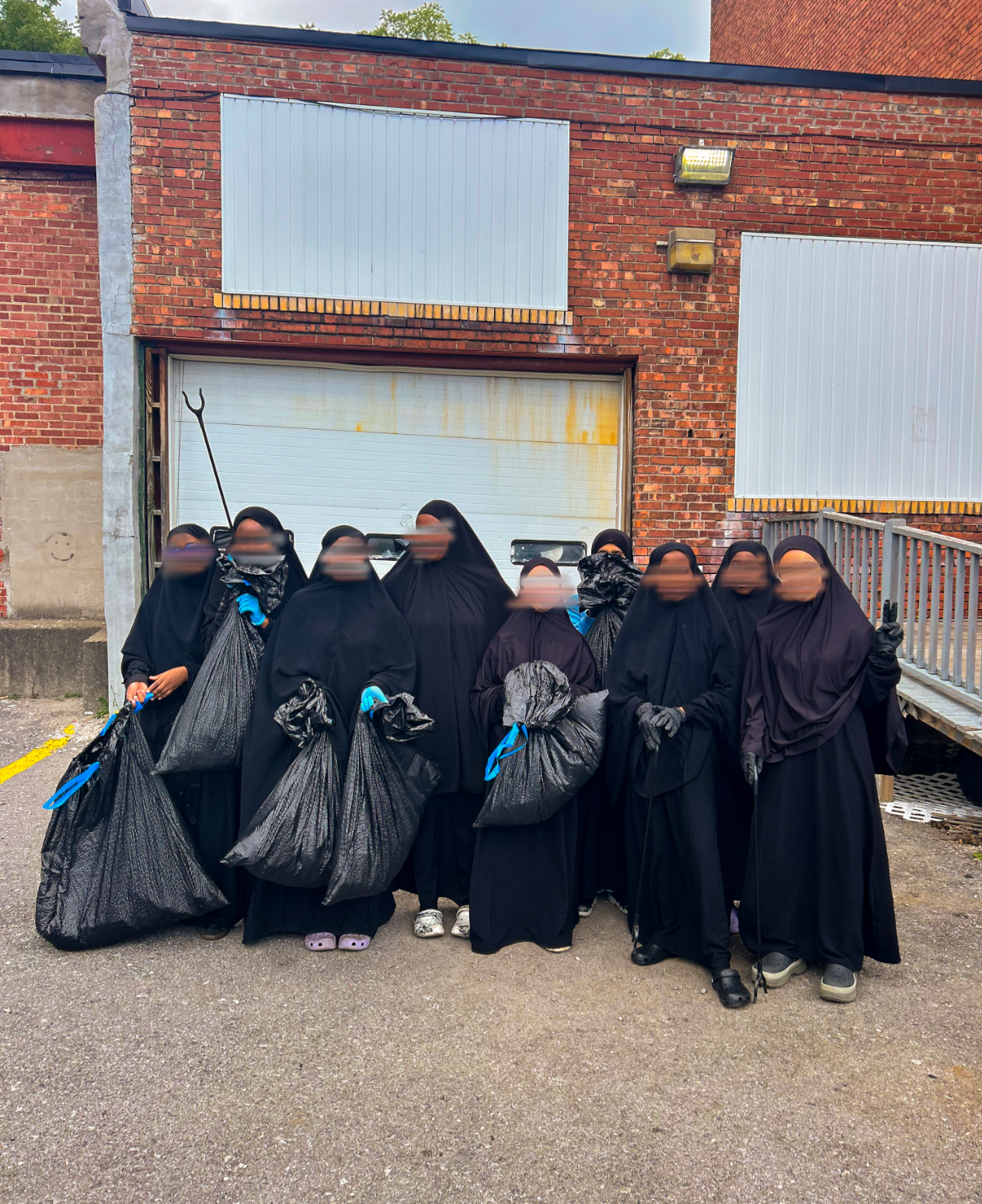 Masjid Bilal youth with bags of trash collected during the clean-up