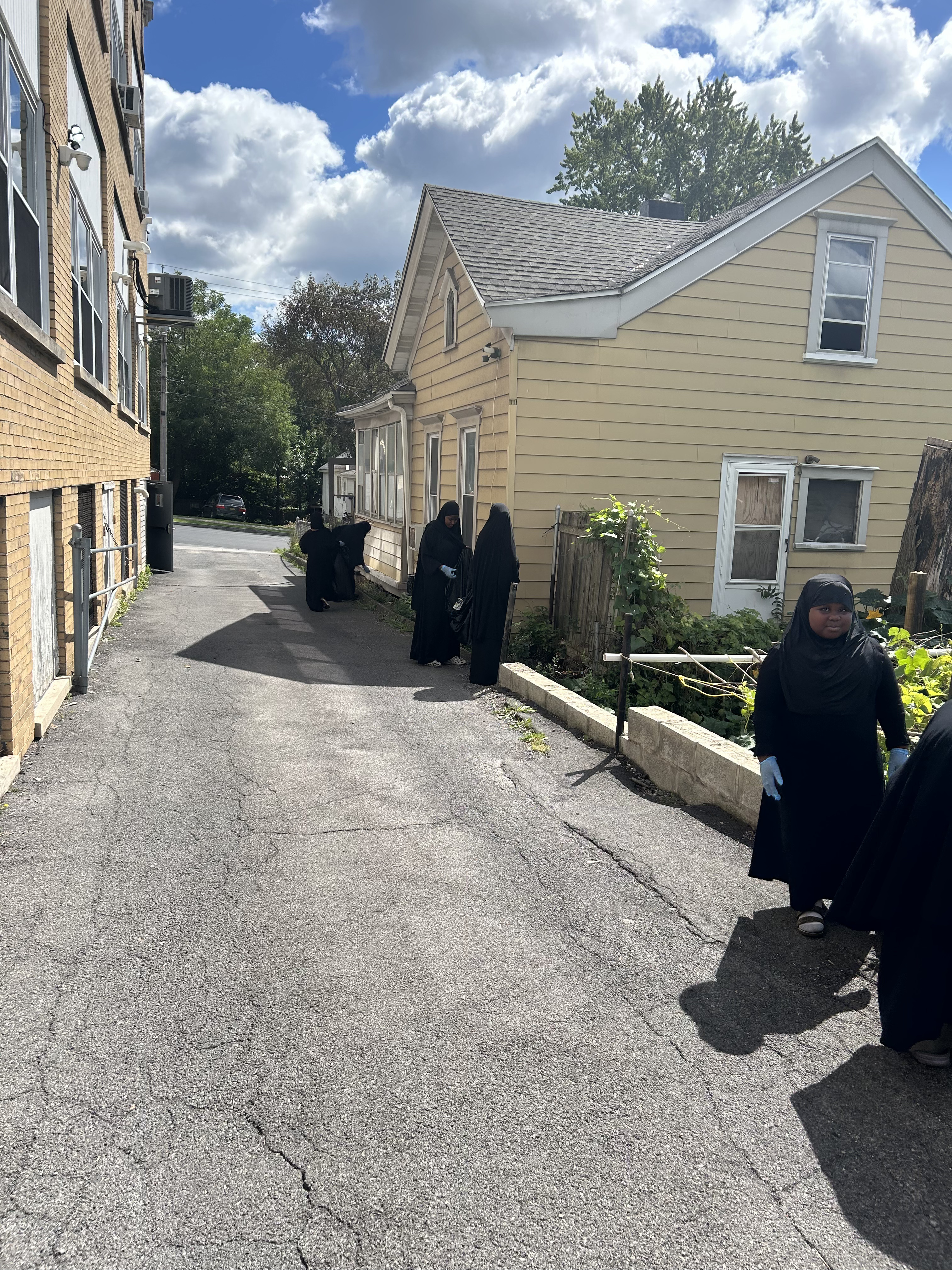 Volunteers picking up litter along the neighborhood sidewalks